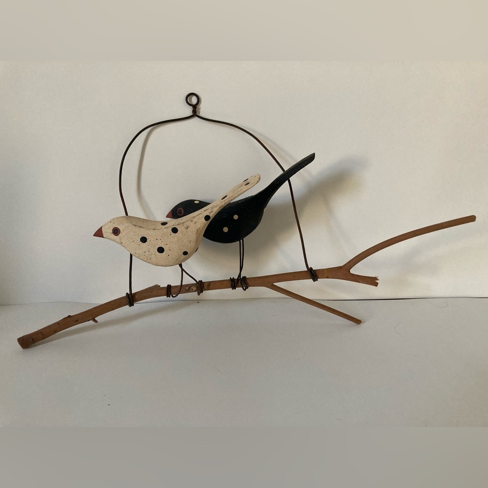 Wooden birds on a branch